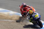 Valentino Rossi on a Fiat Yamaha leading Casey Stoner on a Ducati during a motorcycle race.